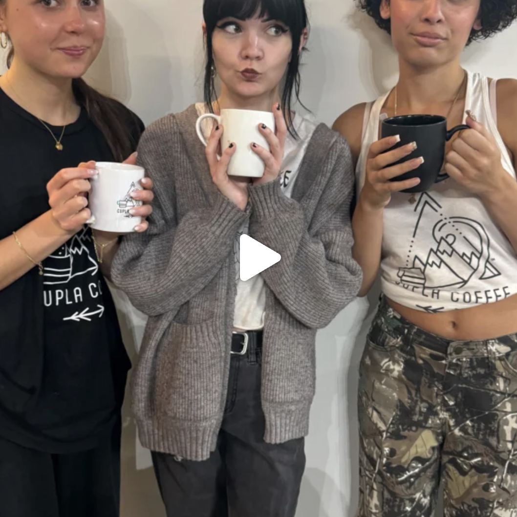 Three friends in Cupla Coffee apparel holding mugs.